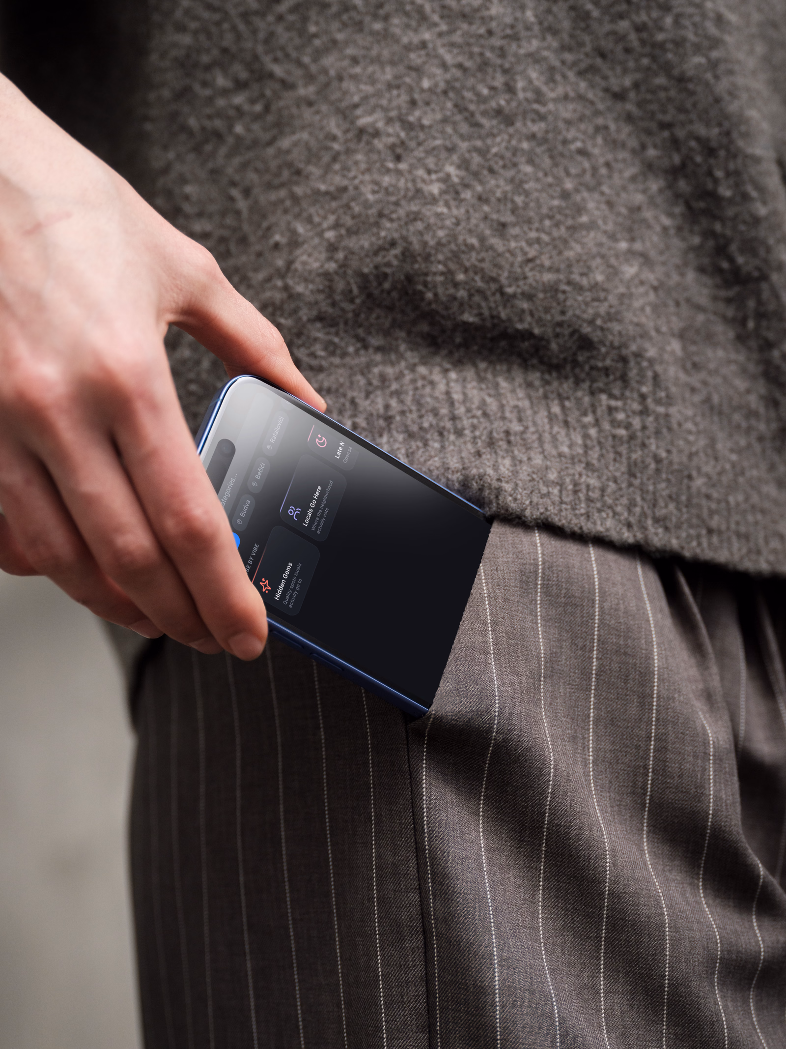 The app in a pocket, showing the browse-by-vibe collections