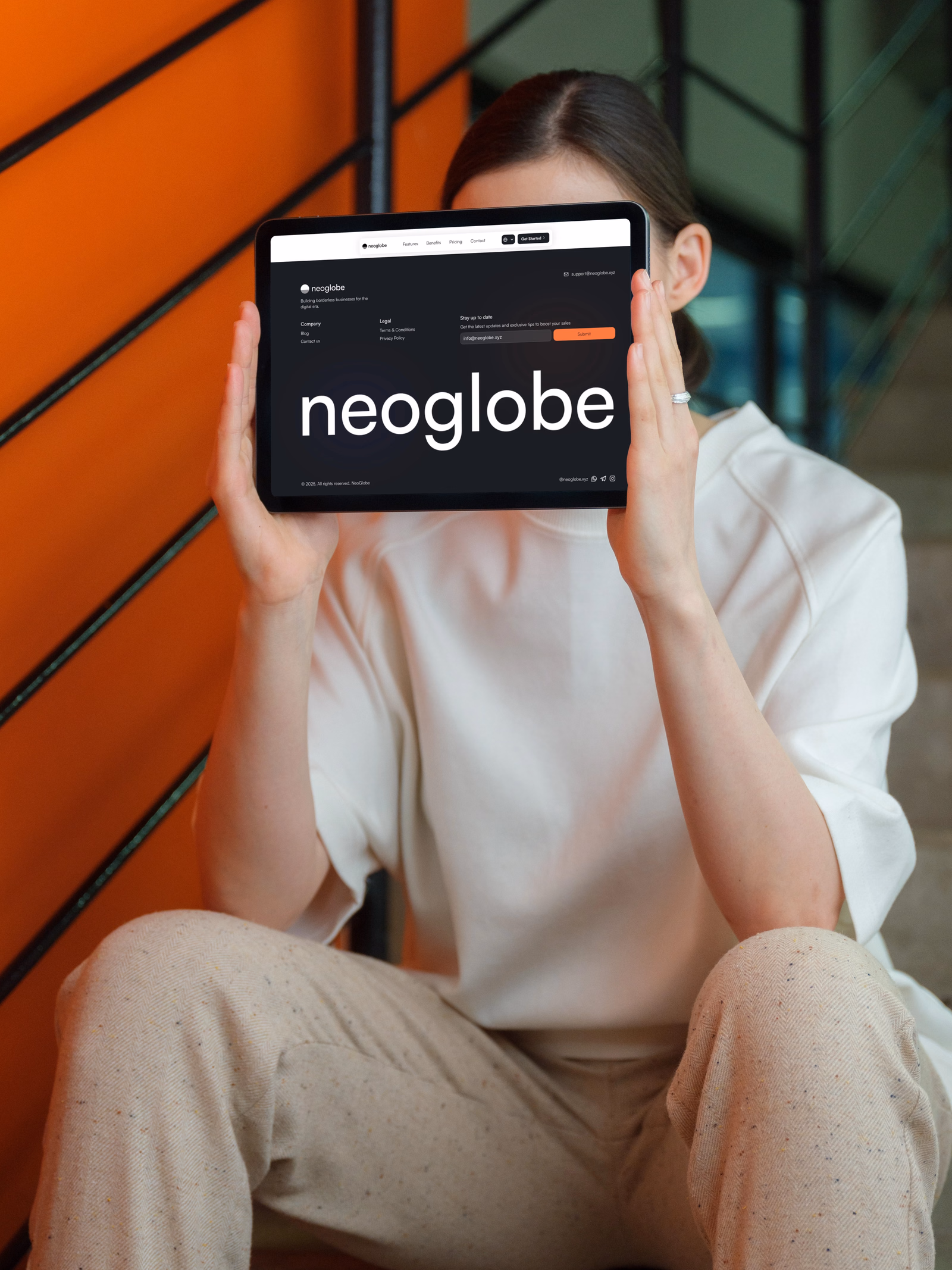 The Neoglobe wordmark, held on a tablet