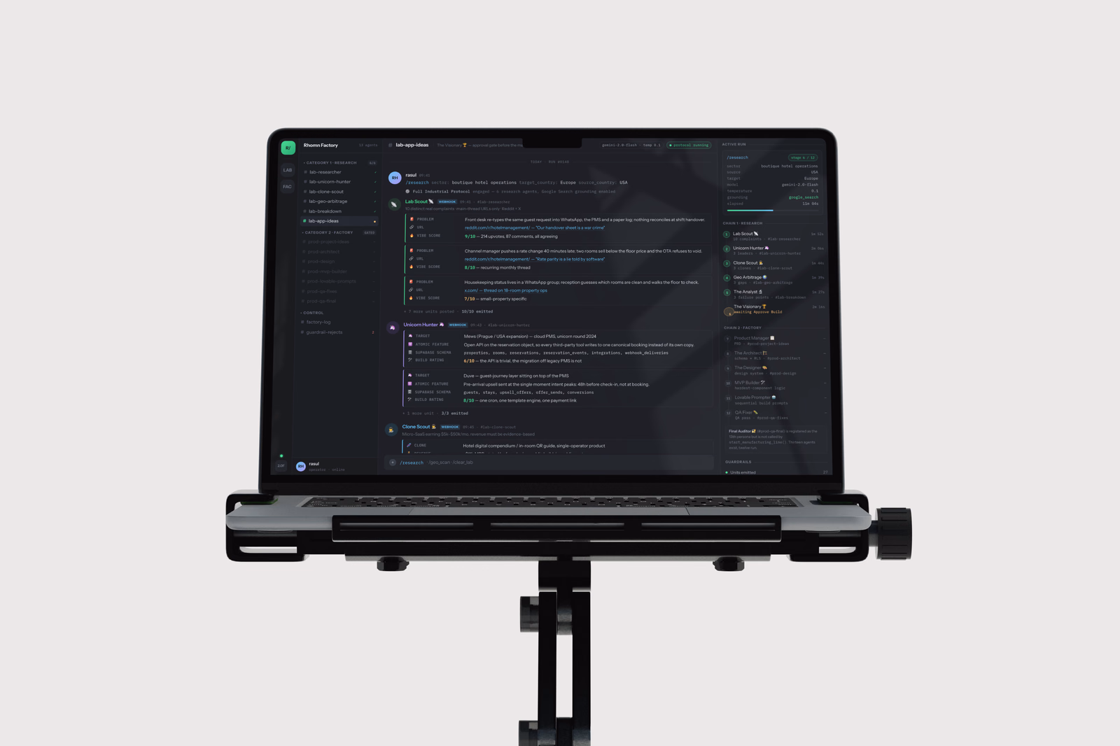 The Rhomn Factory console: both agent chains running, each specialist reporting into its own channel, with The Visionary waiting on an Approve Build